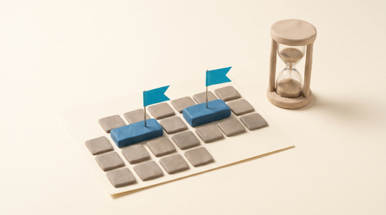 A clay calendar grid with two dates pinned