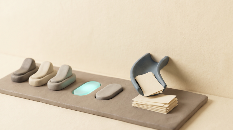 Clay toggles and chips funnelling paper cards into a pile