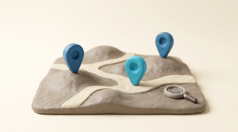 A clay relief map with three location pins